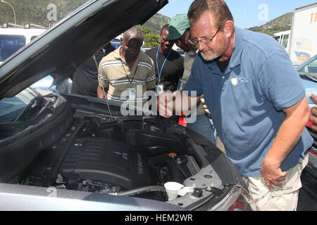 120221-A-IP644-145 CAP HATIEN, HAITI (February 21, 2012) Tom Crall, a physical security specialist for the Naval Criminal Investigative Service (NCIS) embarked on High Speed Vessel (HSV-2) Swift, demonstrates how to perform a vehicle inspection with the Authority Port Nationals (APN) in Haiti, during HSV-Southern Partnership Station 2012 (HSV-SPS 12). HSV-SPS is an annual deployment of U.S. Navy ships and assets to the U.S. Southern Commands area of responsibility in the Caribbean, Central and South America. (U.S. Army photo by Spc. Jennifer Grier, 55th Signal Company (COMCAM)/Released) Public Stock Photo