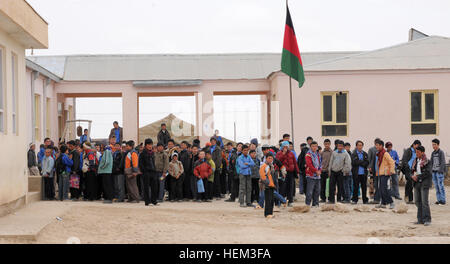 Young Afghan boys stand outside of the Aliabad School near Mazar-e-Sharif, Afghanistan, March 10, 2012. Their new school, a project started by the 1st Brigade, 10th Mountain Division and continued by the 170th and 37th Infantry Brigade Combat Teams, is being built next to the current school and will accommodate the current volume of students with additional room for the town's growing population. (37th IBCT photo by Sgt. Kimberly Lamb) (Released) Aliabad School in northern Afghanistan Stock Photo