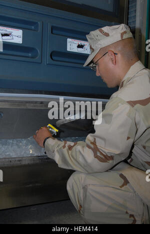 GUANTANAMO BAY, Cuba – Navy Petty Officer 3rd Class Nicholas Ullrich, a preventive medicine technician with Joint Task Force Guantanamo, tests a sample of ice, Oct. 15, 2009. The JTF galleys, and all galleys at U.S. Naval Station Guantanamo Bay, are regularly inspected for sanitation and cleanliness. JTF Guantanamo conducts safe, humane, legal and transparent care and custody of detainees, including those convicted by military commission and those ordered released by a court. The JTF conducts intelligence collection, analysis and dissemination for the protection of detainees and personnel work Stock Photo