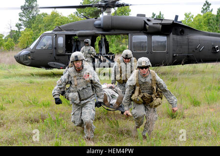 Medics practice loading and unloading casualties from a UH-60 Blackhawk during a casualty evacuation exercise, April 19. During the event, a group of paratroopers assigned to the 2nd Brigade Combat Team, 82nd Airborne Division's 1st Squadron, 73rd Cavalry Regiment, were injured when a roadside bomb detonated along their patrol. The medics triaged and treated the casualties, transported them to the aid station, and evacuated them on a UH-60 Blackhawk. Designed to challenge the medics, the exercise was the culmination of their field training and taught them how to react in a worst-case scenario. Stock Photo