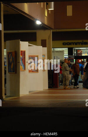 GUANTANAMO BAY, Cuba – Guests gather at the U.S. Naval Station Guantanamo Bay Navy Exchange to view an art exhibit by an artist deployed to Joint Task Force Guantanamo, Oct. 26, 2009. Army Lt. Col. Miguel Angel Mendez, with the Puerto Rico Army National Guard was one of two artists featured in the exhibit. JTF Guantanamo conducts safe, humane, legal and transparent care and custody of detainees, including those convicted by military commission and those ordered released by a court. The JTF conducts intelligence collection, analysis and dissemination for the protection of detainees and personne Stock Photo