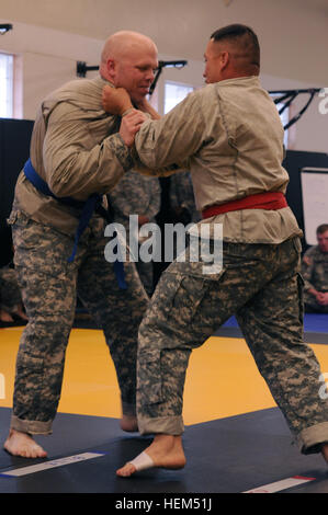 Staff Sgt. Eugene Patton (top), Colorado Army National Guard, grapples with Sgt. 1st Class Maurice Gomez, New Mexico Army National Guard, during their combatives bout in the 2012 Region VII Best Warrior Competition at Camp San Luis Obispo, Calif., April 25. The combatives event challenged competitors to submit their opponent within six minutes using an authorized hold, or win by majority of points gained throughout the match using various moves. (Army National Guard photo/Spc. Grant Larson) The best warriors in Region VII clash to earn the right to compete at Nationals 120425-A-PP889-446 Stock Photo