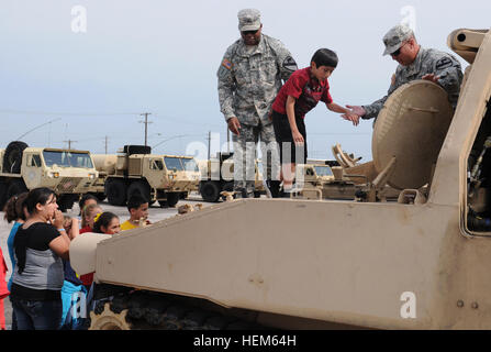 Climbing to the driver’s hatchFORT HOOD, Texas – A 5th grade student from Southwest Elementary (SWE) School, Belton, is helped into the driver’s hatch of an Army Carrier Ammunition Tracked Vehicle (CATV) by Soldiers from the 3rd Battalion, 82nd Field Artillery “Red Dragons,” 2nd Brigade Combat Team, 1st Cavalry Division, during the Red Dragon-SWE adopt-a-school field trip on Fort Hood May 14.  (U.S. Army photo by Sgt. Quentin Johnson, 2/1 CAV PAO) 'Red Dragon' troops host school field trip 120514-A-CJ112-610 Stock Photo