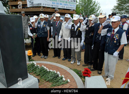 Members of the Korean War Veteran Chilgok Association salute the Hill 303 monument after laying flowers during the Hill 303 Wreath Laying and Memorial Ceremony June 15. Hill 303 was a major battle site during the Korean War where the U.S. 1st Cavalry Division sacrificed their lives in the successful defense of Waegwan. Hill 303 Wreath Laying and Memorial Ceremony 603416 Stock Photo