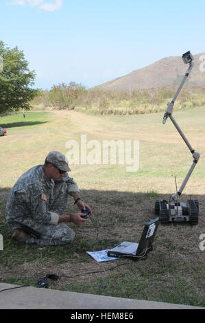 Staff Sgt Frederick Fries, currently with the 319th EOD, Camp Murray, Wash., demonstrates the limits of the 'pac bot' irobot, July27, 2012, at Camp Santiago, Puerto Rico, during Team leader certification training. IRobot 120727-A-HC609-021 Stock Photo