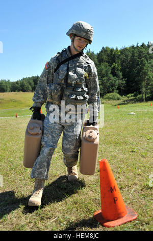 U.S. Army Sgt. Bob Hall, assigned to U.S. Army Europe, carries full water canisters through the stress shoot lane during Europe's 2012 Best Warrior Competition, hosted by the Joint Multinational Training Command, also known as JMTC, at Grafenwoehr, Germany, Aug. 1, 2012. The four-day competition challenges soldiers and noncommissioned Officers in warrior tasks and drills, decision-making, problem-solving and leadership. The winners will be announced during an Aug. 16 award ceremony in Heidelberg, Germany. The winners will attend the Army-wide noncommissioned Officer and soldier of the Year con Stock Photo