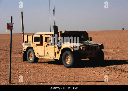 A Humvee stops at a marker during a mounted land navigation training exercise conducted Aug. 17, at Camp Buehring, Kuwait. Soldiers assigned to the 203rd Brigade Support Battalion, 3rd Armored Brigade Combat Team, 3rd Infantry Division, used maps and compasses to obtain the locations of their targets and then entered those locations into Blue Force Tracker devices. The BFT has the capability to track friendly and hostile forces as well assist in navigation from one point to another. Land navigation in the Kuwaiti desert 651089 Stock Photo