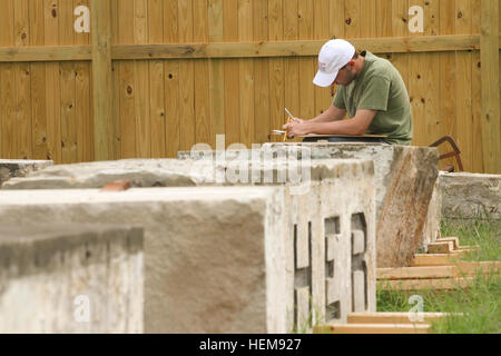 ARLINGTON, Va. – Ryan Pierce, an architect with the National Park Services’ Historic American Building Survey team, makes a detailed hand sketch of pieces of sandstone columns that once stood at the War Department, August 15, 2012. The columns were moved to Arlington National Cemetery in 1879 and repurposed as gates at the cemetery until 1971 when the cemetery was expanded and the gates were deemed not large enough to allow vehicle traffic through. The gates have been in storage at the cemetery ever since. The cemetery is working with the U.S. Army Corps of Engineers to determine if the column Stock Photo