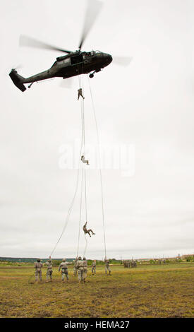 Students of the Fort Hood Air Assault school rappel out of a UH-60 Black Hawk helicopter from A Company 'Werewolves,' 3rd Assault Helicopter Battalion, 227th Aviation Regiment, 1st Air Cavalry Brigade, 1st Cavalry Division, during the Fort Hood Air Assault School's rappel training here Sept. 14. Pilots and crews of the Werewolves flew out in support of Fort Hood's Air Assault School in order to certify pilots and crews, and to also support the school's training of their students. A Company 'Werewolves' spearhead assault training 667588 Stock Photo