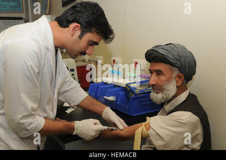 A doctor at Kandahar Regional Medical Hospital draws blood from an Afghan at the hospital on Camp Hero in Kandahar, Afghanistan, Sept. 25, 2012. KRMH is one of five hospitals of its kind in the country and specializes in treating Afghan National Army soldiers and Afghan police members, while also treating civilians. Inside an Afghan security forces%%%%%%%%E2%%%%%%%%80%%%%%%%%99 hospital 120925-A-YE732-027 Stock Photo