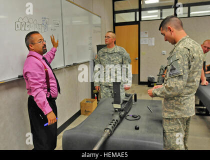 Victor Prieto, (left), a native of El Paso, Texas and weapons instructor at the troop school on Biggs Army Airfield instructs Soldiers on the proper disassembly of an M2 heavy machine gun. During the two-week unit armorer course service members are taught how to perform unit-level maintenance of weapons and how to properly run their unit arms room. Unit armorer course prepares service members to maintain an arms room 757072 Stock Photo