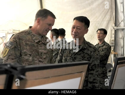 Republic of Korea Army Provincial Reconstruction Team Commander Col. Choi Wan-Kyu shows Maj. Gen. William C. Mayville Jr., Combined Joint Task Force-1, Regional Command East commanding general, several canvases of photos from Korea and ROK Army missions and projects in Afghanistan. The canvases were part of a display for the ROK Armed Forces Day celebration held on Bagram Air Field, Afghanistan, Sept. 28, 2012. The celebration commemorates the day during the Korean War when South Korean forces broke through the 38th parallel. Koreans 'ROK' Bagram for Armed Forces Day 120928-A-XO441-478 Stock Photo