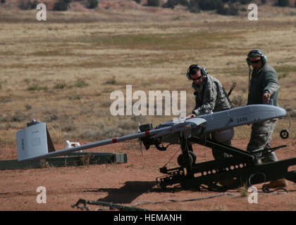 Pfc. Ryan Golden (left) and Sgt. Jacob Schmitt both unmanned aircraft systems repairers, Company A, 2nd Special Troops Battalion, 2nd Brigade Combat Team, 4th Infantry Division, perform a preflight systems check on the Unmanned Aerial Vehicle at Camp Red Devil, Oct. 4, 2012. The Soldiers were launching the UAV as one of the final steps in their recertification. The recertification process lasted two weeks with the first week being in class and the second week being hands-on. There are no test, soldiers must prove they have and understand the knowledge provided or they will not be recertified.  Stock Photo