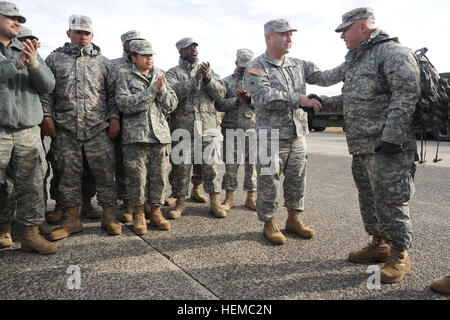 Command Sgt. Maj. Brunk Conley, command sergeant major of the Army National Guard, shakes hands with a soldier from the 719th Transportation Company at Floyd Bennett Field in Brooklyn, N.Y., while presenting him with the coin of the sergeant major of the Army Guard in recognition of the work of the entire unit as part of Hurricane Sandy relief operations Thursday, Nov. 15, 2012. Conley was in New York meeting with soldiers in a number of areas affected by Sandy as a way to gain a greater understanding of the needs and challenges of soldiers on the ground. (U.S. Army photo by Sgt. 1st Class Jon Stock Photo
