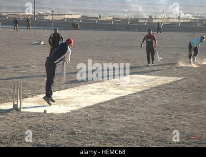 Afghan National Army soldiers play a championship game of cricket against some of the local Afghan interpreters at Forward Operating Base Thunder, Afghanistan, Nov. 19, 2012. Cricket is a popular sport in Afghanistan and numerous leagues are formed at the FOB during the warmer months. (U.S. Army Photo by Sgt. Aaron Ricca, 115th Mobile Public Affairs Detachment) Physical fitness an important part of Afghan Army training 121119-A-VA638-001 Stock Photo