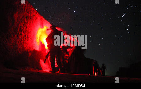 An Afghan and coalition security force prepare to arrest a Taliban facilitator in Kandahar Province, Jan 17, 2013. The detained Taliban facilitator was responsible for coordinating and executing Improvised explosive devices (IED) attacks against Afghan and coalition forces. He over saw the distribution of IED's and other forms of lethal aid to insurgents operating in Arghandab district. (U.S. Army photo by Philip L. Diab) Afghan, coalition security force arrest Taliban facilitator 130117-A-GQ805-017 Stock Photo