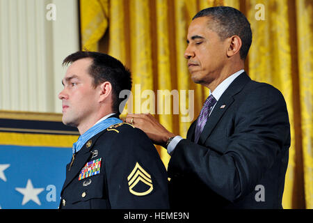 130211-A-NZ457-369President Barack H. Obama awards the Medal of Honor to former Army Staff Sgt. Clinton L. Romesha during a ceremony at the White House in Washington, D.C., on Feb. 11, 2013.  Romesha received the Medal of Honor for his courageous actions during a daylong firefight in Afghanistan in October 2009.  DoD photo by Leroy Council, U.S. Army.  (Released) Barack Obama awards Medal of Honor to Clinton Romesha Stock Photo