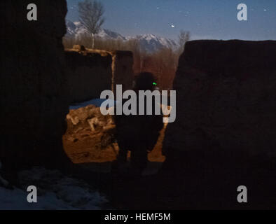 Coalition security force member provides security during an operation in Baraki Barak district, Logar province, Mar. 3, 2013. The operation resulted in the arrest of two insurgents and a Taliban facilitator that was responsible for procuring and distributing weapons for Taliban fighters in Baraki Barak. He also had a history of directing improvised explosive device and small arms attacks against Afghan and coalition forces. (U.S. Army photo by Spc. Stephen Cline) Logar province operations 130302-A-TW399-043 Stock Photo