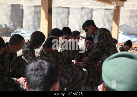 Afghan National Army soldiers observe a pulley being attached to a soldier to show that no matter where they are or the lack of equipment they have they can safely remove an improvised explosive device during a counter IED course on Forward Operating Base Shank, Logar province, Afghanistan, April 1, 2013. The counter IED course offers in-depth information and hands-on training through an interactive environment with various examples of IEDs. (U.S. Army photo by Sgt. Thomas Childs/Released) ANA counter IED training 130401-A-WF228-002 Stock Photo