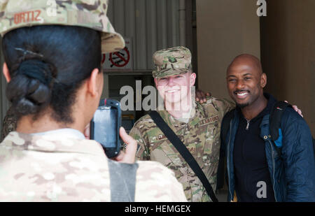 U.S. Air Force Staff Sgt. Charlie Kemmer, a radiology team member with the 455th Expeditionary Medical Group, Task Force Med-East poses for a photo with Hollywood star Romany Malco during Armed Forces Entertainment's 'Ambassadors of Hollywood II' tour at Bagram Air Field in Parwan province, Afghanistan, April 9, 2013. Malco, a comedian, actor and rapper, served in the U.S. Marine Corps.  (U.S. Army photo by Spc. Margaret Taylor/Released) Hollywood celebrities meet service members 130409-A-SW098-011 Stock Photo