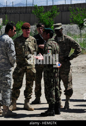 An interpreter listens as an Afghan soldier speaks with British Army Gen. Sir Richard Shirreff, second from left, NATO's Deputy Supreme Allied Commander Europe, and U.S. Army Brig. Gen. Ronald Lewis, right, the 101st Airborne Division's deputy commanding general for support, at Forward Operating Base Gamberi in Laghman province, Afghanistan, April 16, 2013. Shirreff met with U.S. and Afghan soldiers as they conducted counter-improvised explosive device awareness training.  (U.S. Army photo by Staff Sgt. Richard Andrade/Released) Deputy supreme allied commander Europe visits FOB Gamberi 130421- Stock Photo