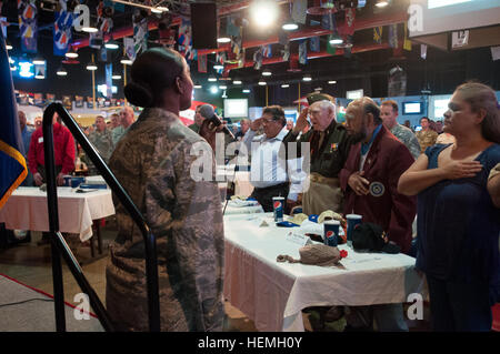 U.S. Air Force Capt. Elenah Kelly, a protocol officer with the 440th Airlift Wing, Pope Army Airfield, N.C., sings 'The Star Spangled Banner' as the U.S. Army Reserve Command honor guard presents the colors during the Eighth Annual Warriors on the Water ice breaker at Sports USA on Fort Bragg, N.C., April 17, 2013. Warriors on the Water is a free military appreciation event that includes a bass fishing tournament.The fishing tournament is April 19, 2013 at Jordan Lake State Recreation Area near Pittsboro, N.C.  (U.S. Army photo by Timothy Hale/Released) Warriors on the Water 2013 ice breaker 1 Stock Photo