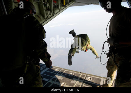 Special operations jumpers from the Canadian Special Operations Regiment, Green Berets of 7th Special Forces Group (Airborne) and Para-rescue Airmen from the Air Force Special Operations Command begin exiting a British C-130 from the Royal Air Force during a high altitude low opening parachute jump (HALO) Hurlburt Field, Fl., April. 25, 2013. Special operations members from coalition forces participated in HALO jumps during Exercise Emerald Warrior, Emerald Warrior is an exercise designed to provide irregular training at the tactical and operational levels. The exercise involved all branches o Stock Photo