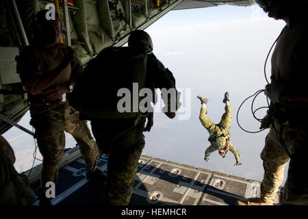 Special operations jumpers from the Canadian Special Operations Regiment, Green Berets of 7th Special Forces Group (Airborne) and Para-rescue airmen from the Air Force Special Operations Command begin exiting a British C-130 from the Royal Air Force during a high altitude low opening parachute jump (HALO) Hurlburt Field, Fla., April. 25, 2013. Special operations members from coalition forces participated in HALO jumps during Exercise Emerald Warrior, Emerald Warrior is an exercise designed to provide irregular training at the tactical and operational levels. The exercise involved all branches  Stock Photo