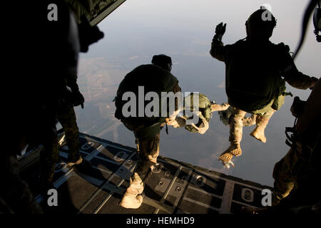 Special operations jumpers from the Canadian Special Operations Regiment, Green Berets of 7th Special Forces Group (Airborne) and Para-rescue Airmen from the Air Force Special Operations Command begin exiting a British C-130 from the Royal Air Force during a high altitude low opening parachute jump (HALO) Hurlburt Field, Fl., April. 25, 2013. Special operations members from coalition forces participated in HALO jumps during Exercise Emerald Warrior, Emerald Warrior is an exercise designed to provide irregular training at the tactical and operational levels. The exercise involved all branches o Stock Photo