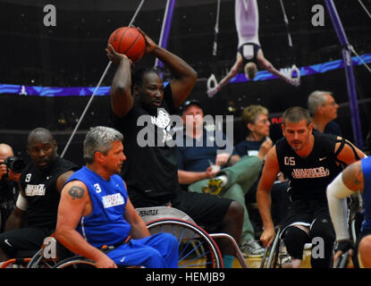 COLORADO SPRINGS, Colo. - Army veteran Anthony Pone from Philadelphia, Pa., attempts to pass the ball during the first match of the Warrior Games' wheelchair basketball event on May 13, 2013. The first match of the night pitted the Army against the Air Force and resulted in a strong win for the Army. The weeklong event began May 11 and pits 260 wounded, ill or injured service members from across the Department of Defense and United Kingdom against each other. Service members will compete in track and field, sitting volleyball, shooting, swimming, archery, and cycling. (Photo by Sgt. Victor J.  Stock Photo