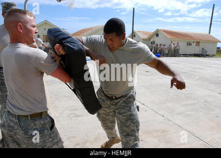 GUANTANAMO BAY, Cuba – Soldiers from the 525th Military Police Battalion participate in a pepper spray familiarization training at Joint Task Force Guantanamo’s Camp America, Oct. 30, 2008. During this standard Army training, Soldiers are sprayed with pepper spray and then must complete a combatives-simulation exercise.   JTF Guantanamo conducts safe, humane, legal and transparent care and custody of detained enemy combatants, including those convicted by military commission and those ordered released. The JTF conducts intelligence collection, analysis and dissemination for the protection of d Stock Photo