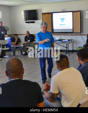 Gerry Dooley, team leader, Living Works Organization, teaches Fort Carson soldiers and leaders about suicide intervention and prevention during their Applied Suicide Intervention Skills Training at Provider Chapel on Fort Carson, Colo., July 10, 2013. Fourth Combat Aviation Brigade Chaplain's Office, 4th Infantry Division, hosted the 'train the trainer' classes for all of post. Living Works, an international organization that creates suicide intervention programs from Calgary, Alberta, in Canada, provided the instructors to teach the Applied Suicide Intervention Skills Training. (Photo by Sgt. Stock Photo