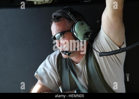 U.S. Army Sgt. 1st Class Sean Foley, jumpmaster, assigned to the 982nd Combat Camera Company (Airborne), East Point, Ga., sits inside a UH-60 Black Hawk during helocast operations training at Tampa Bay, Fla., July 27, 2013. Soldiers with 982nd Combat Camera Company (Airborne) stand by in boats to recover fellow soldiers out of the water. (U.S. Army photo by Spc. Tracy McKithern/Released) Helocast operations 130727-A-LC197-443 Stock Photo