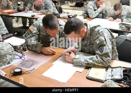 Capt. Joshua Withington, commander of Brigade Headquarters Company, 1st Stryker Brigade Combat Team, 25th Infantry Division, and Capt. Gary Goodman, Headquarters Troop, 5th Squadron, 1st Cavalry Regiment, Commander plot points on a map before land navigation at the Northern Warfare Training Center in Black Rapids, Alaska Sept. 3. (U.S. Army photo by Sgt. Michael Blalack, 1/25 SBCT Public Affairs) Operation Wolfpack 130903-A-AX238-003 Stock Photo