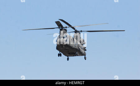 A 10th Combat Aviation Brigade CH-47 Chinook helicopter flies a personnel and equipment movement mission, Sept. 22, over Ghazni province, Afghanistan. The CH-47 is the U.S. Army's premiere heavy lift assists and plays a critical role in transporting troops and equipment around the battlefield. 10th Combat Aviation Brigade Chinooks in action 130922-A-SM524-496 Stock Photo