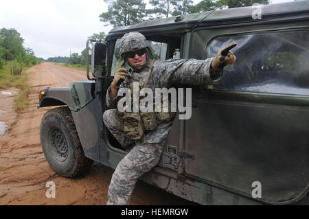 48th Infantry Brigade XCTC GEORGIA GARRSON TRAINING CENTER, Fort Stewart, Ga. Sept. 22, 2013 –  Sitting in a humvee using the radio, Georgia Army National Guardsman Sgt. Kyle Black, a convoy commander with Charlie Company, 2nd Battalion, 121st Infantry, sets up a hasty defensive position while directing vehicles in his resupply convoy which are in route to provide support to objective “Cobra” during eXportable Combat Training Capabilities (XCTC) training at Fort Stewart. Black is a Buford, Ga., native. He is a full-time student at Liberty University studying business management. He has been in Stock Photo