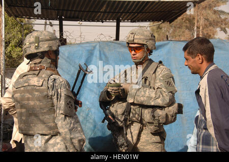 U.S. Army 1st Lt. Brent Slough from Alpha Company, 1st Battalion, 64th Armor Regiment, 2nd Brigade Combat Team, 3rd Infantry Division, Ft. Stewart, Ga, documents identification information of an Iraqi local during a patrol in Adl, Iraq, on Sep. 21, 2007. Day Patrol 68136 Stock Photo