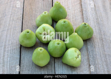 Freshly picked Syzgium samarangense or known as Wax Jambu or Bell Apples isolated against wooden background Stock Photo