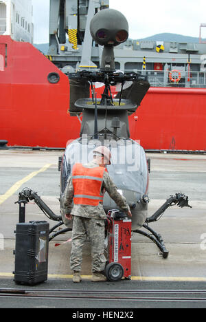 Cpl. Timothy R. Davis, an OH-58D  armament/electrical/avionics systems repairer with 4th Attack Reconnaissance Squadron, 6th Cavalry Regiment, 16th Combat Aviation Brigade and native of Manteca, Calif., conducts maintenance on an OH-58D Kiowa Warrior helicopter at the port of Pier 8 Oct. 6, 2013 in Busan, South Korea.  (U.S. Army photo by Staff Sgt. Vincent Abril, 2nd CAB PAO) 4-6 ARS equipment floats into port 131006-A-ZF701-007 Stock Photo