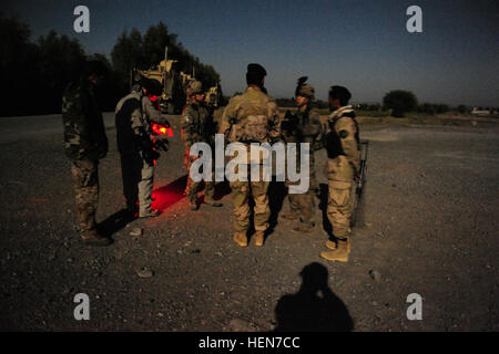 Leaders from Easy Company, 2nd Battalion, 506th Infantry Regiment, 4th Brigade Combat Team 'Currahee', 101st Airborne Division (Air Assault) link-up with their Afghan National Security Force counterparts before sunrise outside of Forward Operating Base Salerno, Afghanistan, Oct. 20, 2013. The Soldiers conducted a partnered operation with the newly formed Khowst Provincial Response Company. The operation was used to validate the training that the Khwost PRC recently received and ensure that illegal weapons were not being stored in historical weapons cahce points. Easy Company conducts partnered Stock Photo