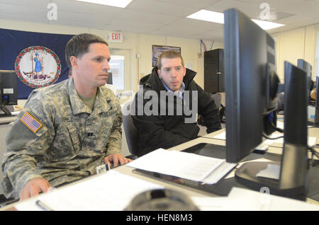 Capt. William Perez of the Virginia National Guard's 1945th Contingency Contracting Team gets assistance on the Joint Contingency Contracting System from a Defense Logistics Agency employee Nov. 14, 2013, at Camp Pendleton, Va., during Vital Pledge, a six-day, joint, multi-state, contracting exercise. The exercise served to help prepare the four Soldiers from the 1945th CCT for their upcoming deployment to Afghanistan in early 2014 by improving their familiarity with contracting processes, legal requirement and systems. (Photo by Master Sgt. A.J. Coyne, Virginia Guard Public Affairs) Va. Guard Stock Photo