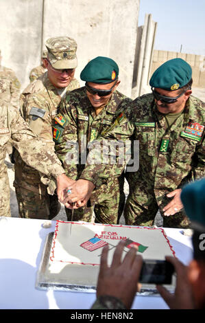 U.S. Army Lt. Col. Eric Smith (left), commander of 3rd Squadron, Combined Task Force Dragoon, Afghanistan National Army Lt. Col. Babakhan Hassani (middle), commander of 4th Kandak and Col. Said Zainuddin Rohani (right), commander of 6th Kandak, both with 3rd Brigade, 205th Corps, cut a cake together after a transfer ceremony Nov. 15, 2013, at Forward Operating Base Azizullah, Afghanistan. Troops with 3rd Squadron relinquished authority over the base to the ANA and Afghan National Civil Order Police in support of Operation Enduring Freedom. (U.S. Army Photo by Spc. Joshua Edwards) Cake cutting  Stock Photo