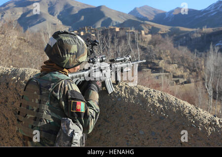 A U.S. Special Forces soldier assigned to the Combined Joint Special Operations Task Force-Afghanistan, surveys the valley for any suspicious activity during an operation in Ghorband district, Parwan province, Afghanistan, Jan. 15, 2014.  Afghan and U.S. forces conducted the operation with the goal of capturing several high value targets known for Taliban activity. (U.S. Army photo by Spc. Connor Mendez/Released) An Afghan National Army soldier surveys a valley for suspicious activity during an operation in Ghorband district, Parwan province, Afghanistan, Jan. 15, 2014 140115-A-CL980-187 Stock Photo