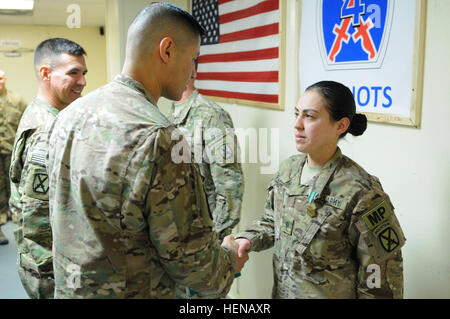 U.S. Army Spc. Clorinda Placencia, a military police officer with 4th Brigade Special Troops Battalion, from San Bernardino, Calif., accepts the congratulations of Col. Mario Diaz, commander, 4th Brigade Combat Team, 10th Mountain Division, Task Force Patriot, for being named the 1st Quarter, 2014, Brigade Soldier of the Quarter Jan. 24 at Forward Operating Base Fenty. Placencia, the only female competing for the title, went up against soldiers from across the brigade in a two day, multi-event contest that tested the troops' marksmanship, fitness, competence, and ability in several different s Stock Photo