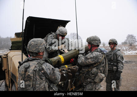 Paratroopers assigned to Destined Company, 2nd Battalion, 503rd Infantry Regiment, 173rd Infantry Brigade Combat Team (Airborne) out of Vicenza, Italy, prepare to transport a TOW 2b missile to the firing lane, during a live-fire exercise at the Joint Multinational Training Command in Grafenwoehr, Germany, Feb. 1. (Photo by US Army Staff Sergeant Pablo N. Piedra/released) Live-fire TOW 2B exercise 140201-A-KG432-017 Stock Photo