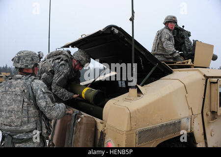 Paratroopers assigned to Destined Company, 2nd Battalion, 503rd Infantry Regiment, 173rd Infantry Brigade Combat Team (Airborne) out of Vicenza, Italy, prepare to transport a TOW 2B missile to the firing lane during a live-fire exercise at the Joint Multinational Training Command in Grafenwoehr, Germany, Feb. 1. (Photo by U.S. Army Staff Sgt. Pablo N. Piedra/released) Live-fire TOW 2B exercise 140201-A-KG432-055 Stock Photo
