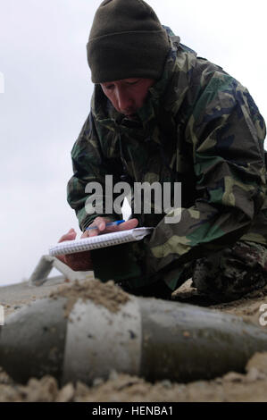 A 201st Afghan National Army Corps soldier investigates a piece of unexploded ordnance in the rain while training with explosive ordnance disposal soldiers from the 663rd EOD Company, Feb. 6, 2014, at Forward Operating Base Gamberi. The 201st Corps soldiers conducted the training to prepare themselves for the ANA EOD school. (U.S. Army Photo by Spc. Eric Provost, Task Force Patriot PAO) Soldiers show Afghans ropes of explosive ordnance disposal 140206-A-CB167-002 Stock Photo