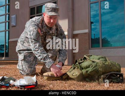 Master Sgt. Chris Pair, 33, USARCENT telecommunication systems noncommissioned officer, conducts an inventory of his first aid bag. Pair helped save the lives of two teenagers involved in a one-car accident in Sumter, S.C., Feb. 15. (Photo by Sgt. Sharmain Burch, USARCENT Public Affairs) 'Always First'- US Army Central soldier first responder to life-threatening accident following recent ice storms 140221-A-XY911-002 Stock Photo