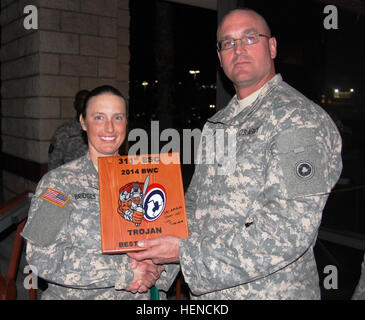 Command Sgt. Maj. Ted Copeland, 311th  Sustainment Command (Expeditionary) command sergeant major, awards Spc. Erin Bridges, 711th Transportation Company, the junior enlisted winner's plaque at the Best Warrior competition at Marine Corps Base Camp Pendleton March 7-9. Bridges was named 'Best Warrior' for the event. The 311th ESC conducts Best Warrior Competition 140309-A-VA095-903 Stock Photo