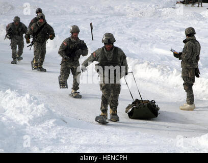 Soldiers from 1st Battalion, 24th Infantry Regiment, 1st Stryker Brigade Combat Team, 25th Infantry Division, pull a simulated casualty in a SKEDCO sled on the medical evaluation event, one of seven events in the U.S. Army Alaska Winter Games at Fort Wainwright, Alaska March 10-13.  The games are designed to test the Soldiers’ ability to execute required cold-weather skills and tasks with realistic challenges the 29, ten-man teams from across Alaska are competing in. (Photo by Staff Sgt. Mylinda DuRousseau, 1/25 SBCT Public Affairs) US Army Alaska Winter Games 2014 140312-A-SF624-145 Stock Photo